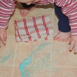 Toddler cleans the floor with Bubbles