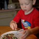 little boy sorting with cups
