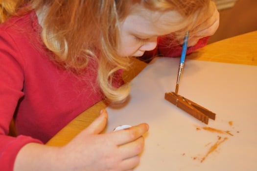 girl painting clothespin
