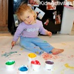 little girl painting on floor