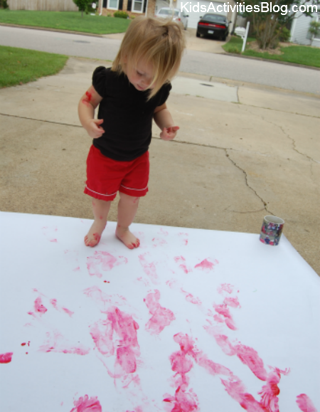 little girl painting red feet