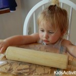 little girl rolling graham crackers