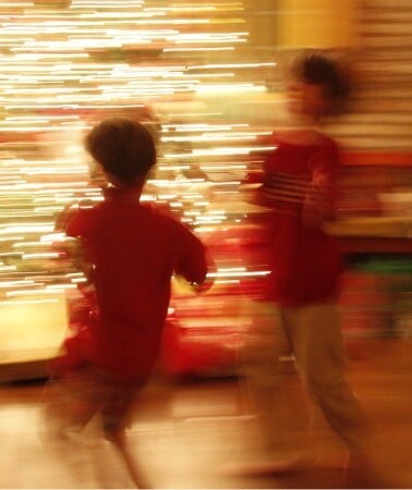 two boys in front of a Christmas tree