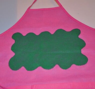 pink apron green splotch