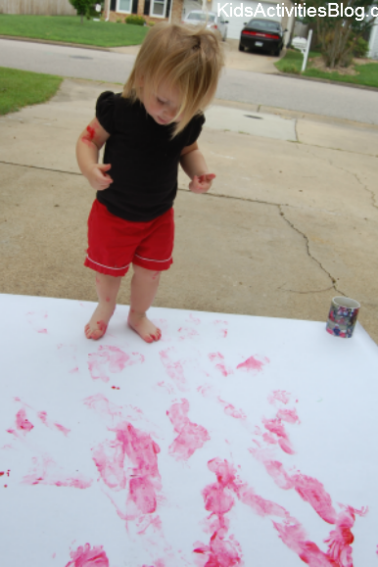 little girl painting red feet