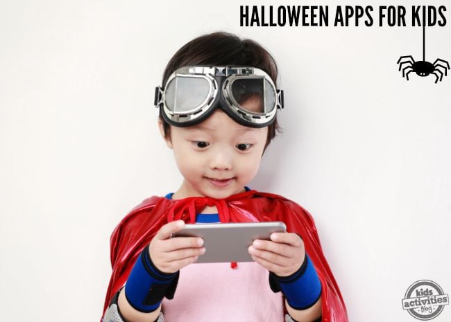 Halloween Apps for Kids with a child playing on a phone dressed up with goggles and capes.