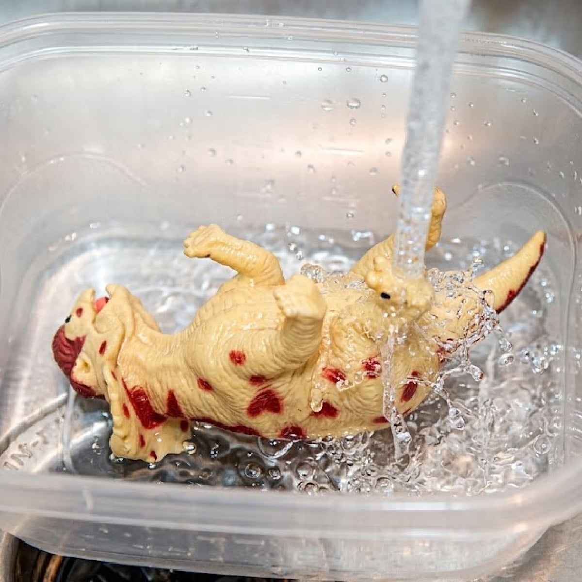 Dinosaur Activity- Step 1- Fill tub with water and dinosaur- Kids Activities Blog