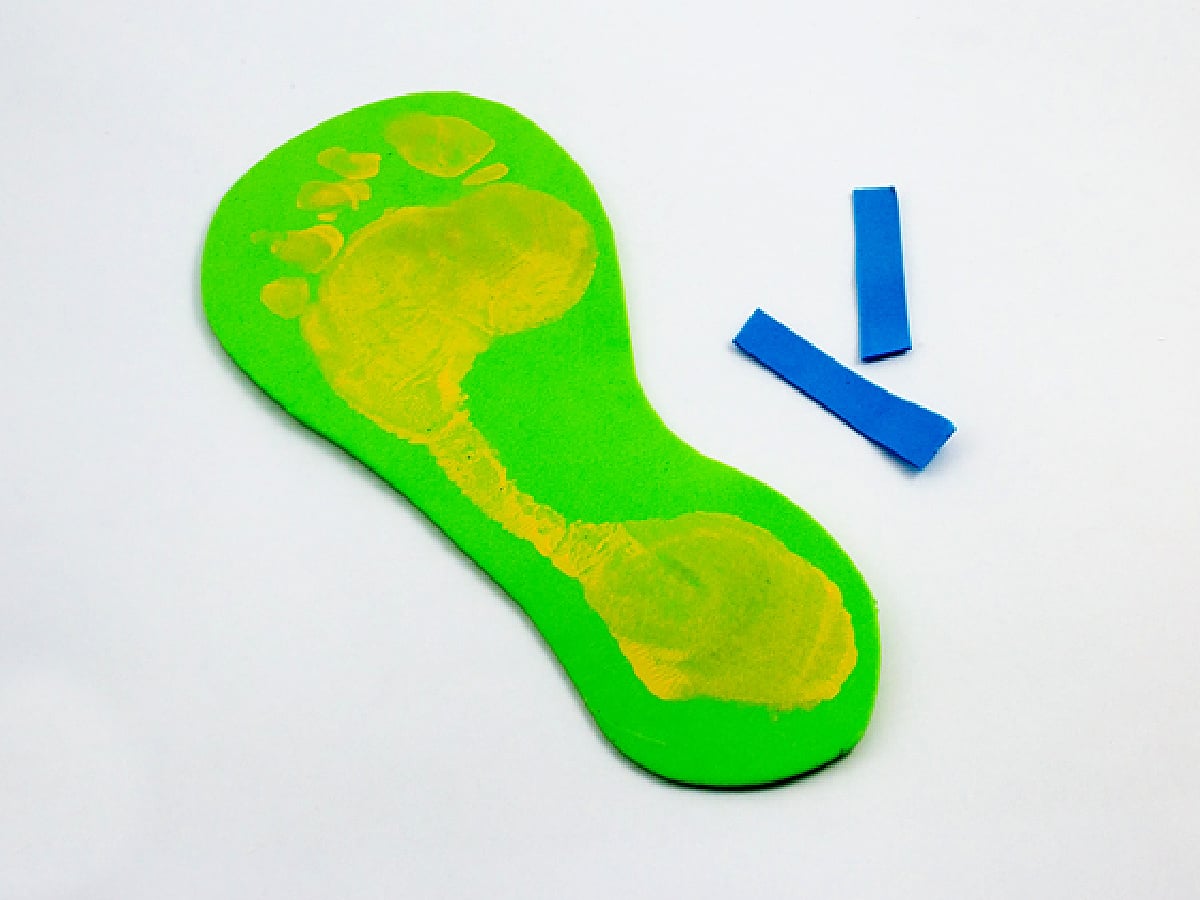 Sandal Craft- Step 2- straps cut from blue foam with paper sandal- kids activities blog