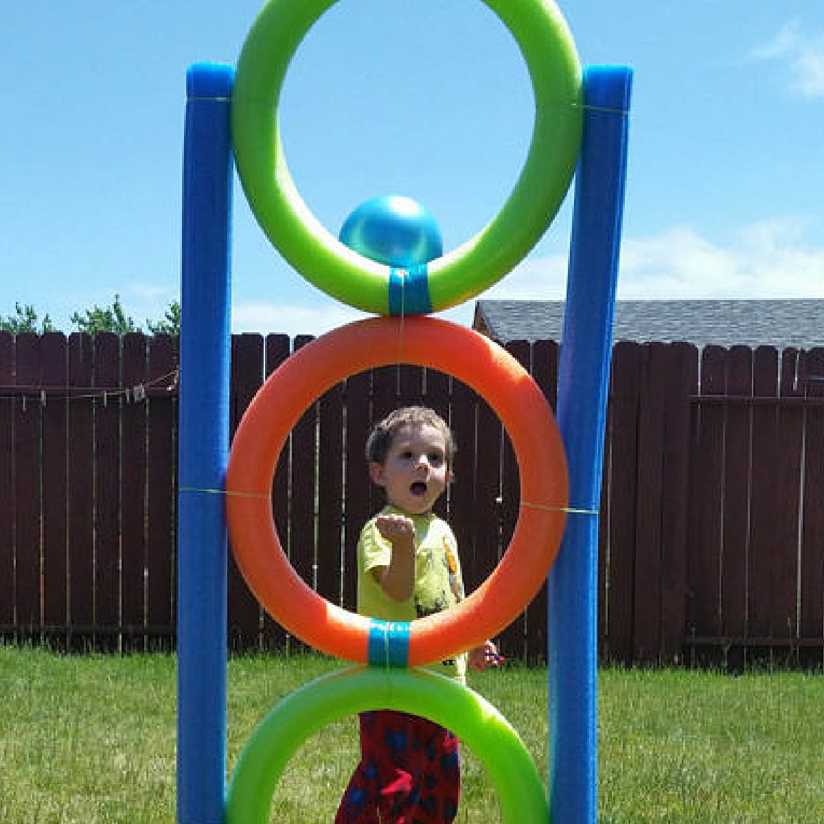 Pool Noodle Activities- hoops with a boy throwing a ball through - Kids Activities Blog
