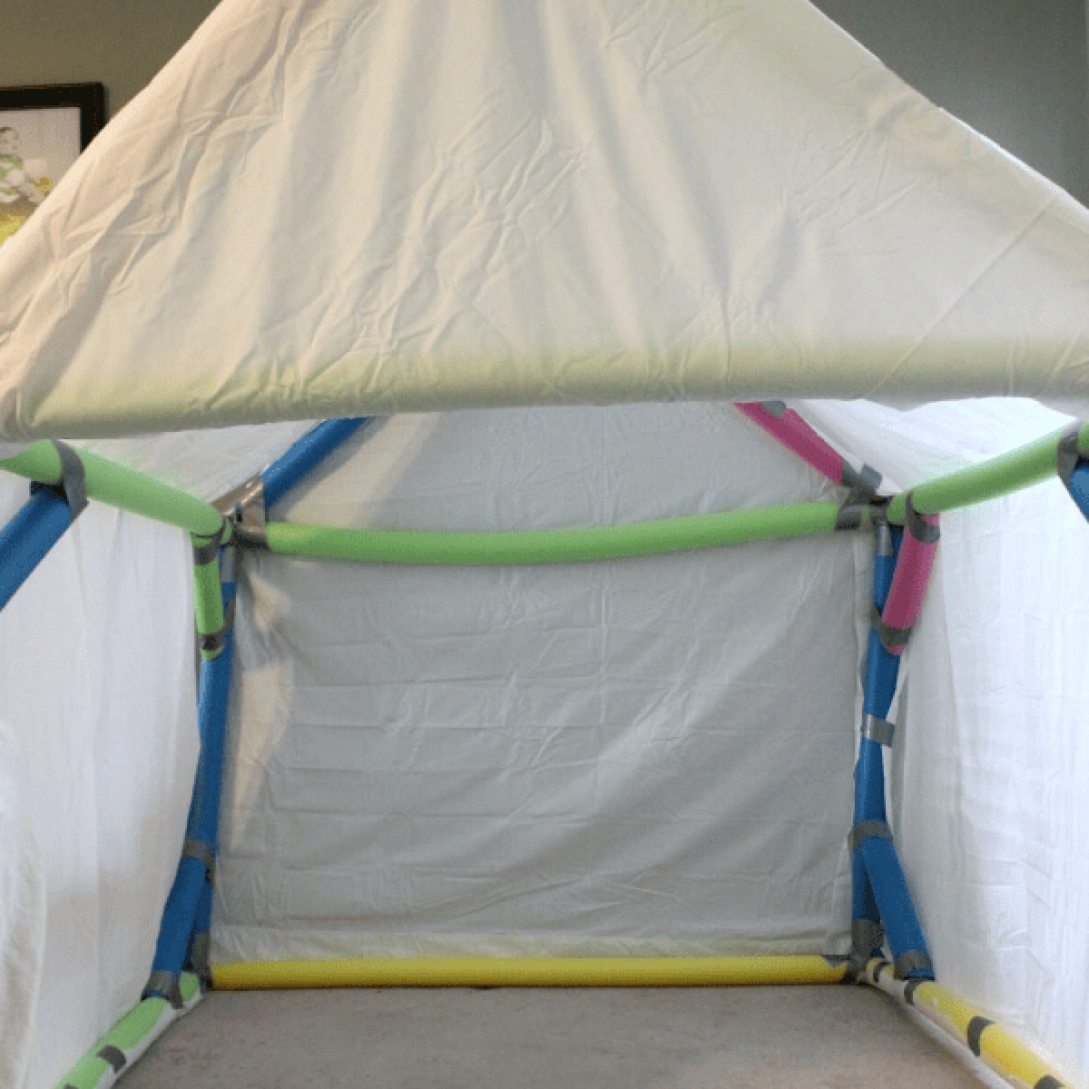 Pool Noodle Activities- playhouse made with tape, noodles, and sheet - Kids Activities Blog