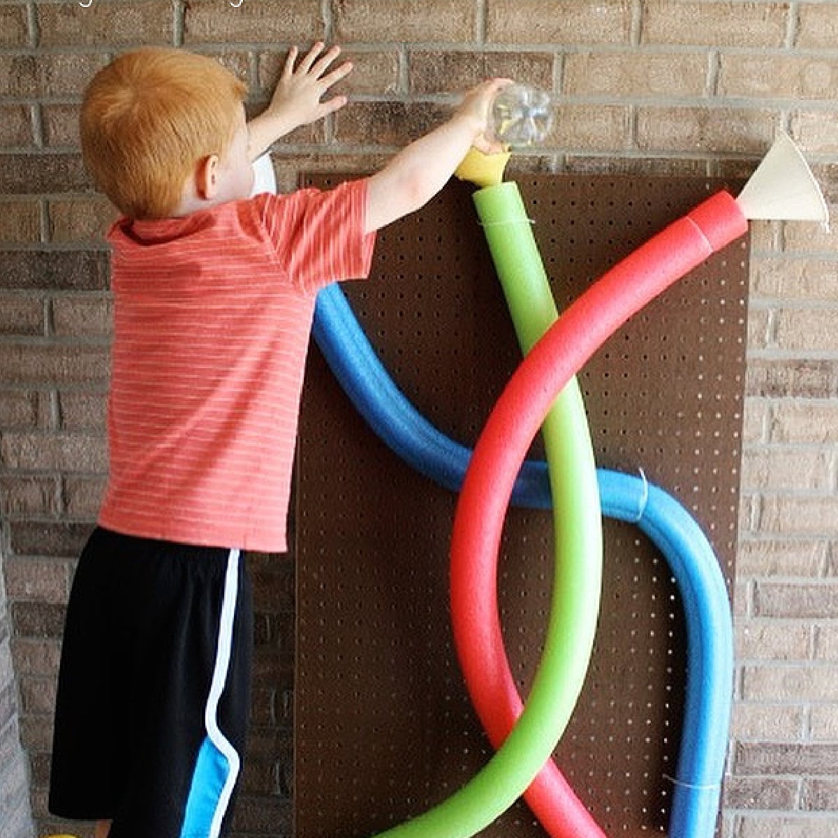 Pool Noodle Activities- water wall using red green and blue noodles- Kids Activities Blog