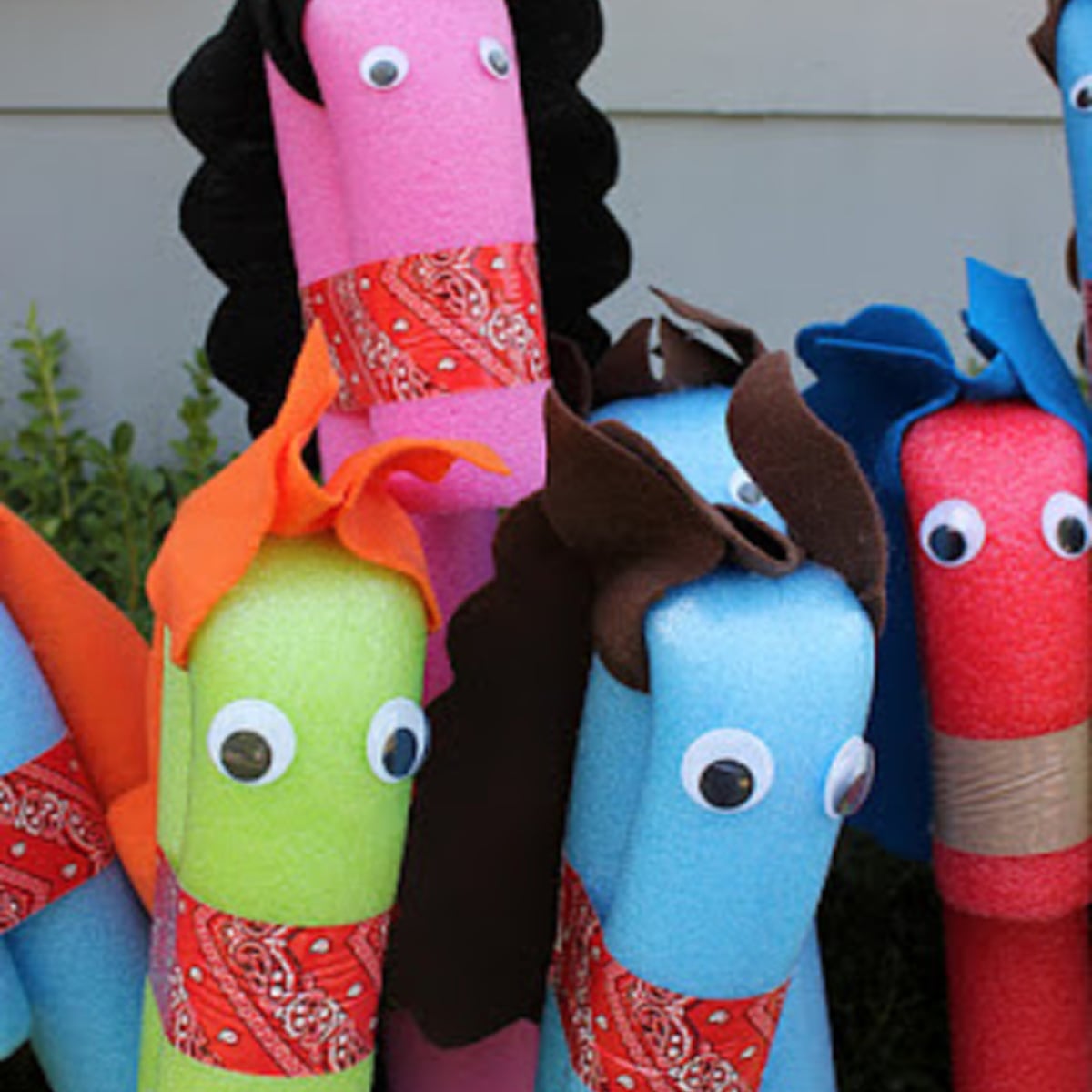 Pool Noodle Activities- pink green blue red faux horses with eyes, manes, and tape - Kids Activities Blog