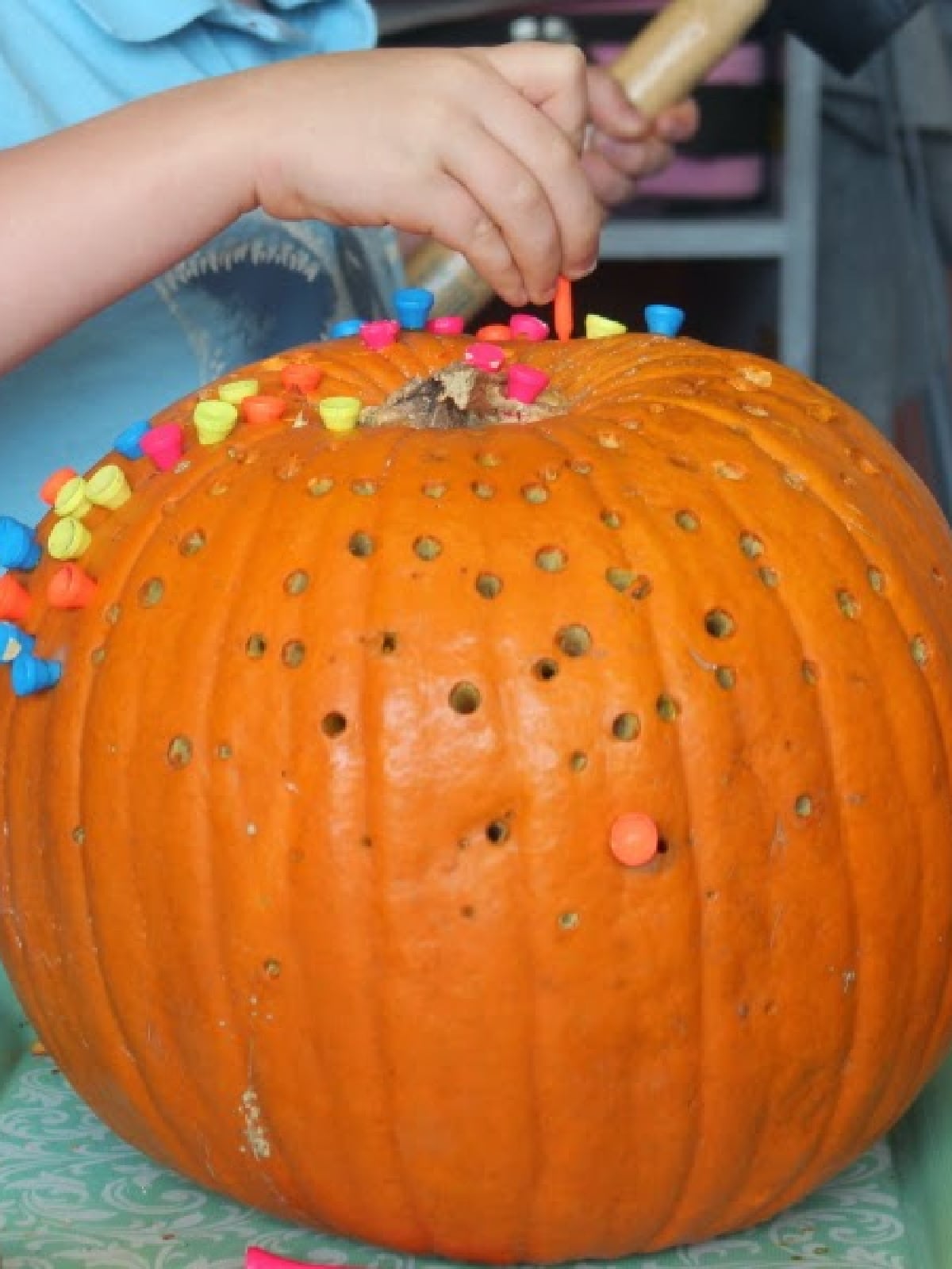 Pumpkin Activities- Pumpkin fine motor skill with pegs in a pumpkin- Kids Activities Blog