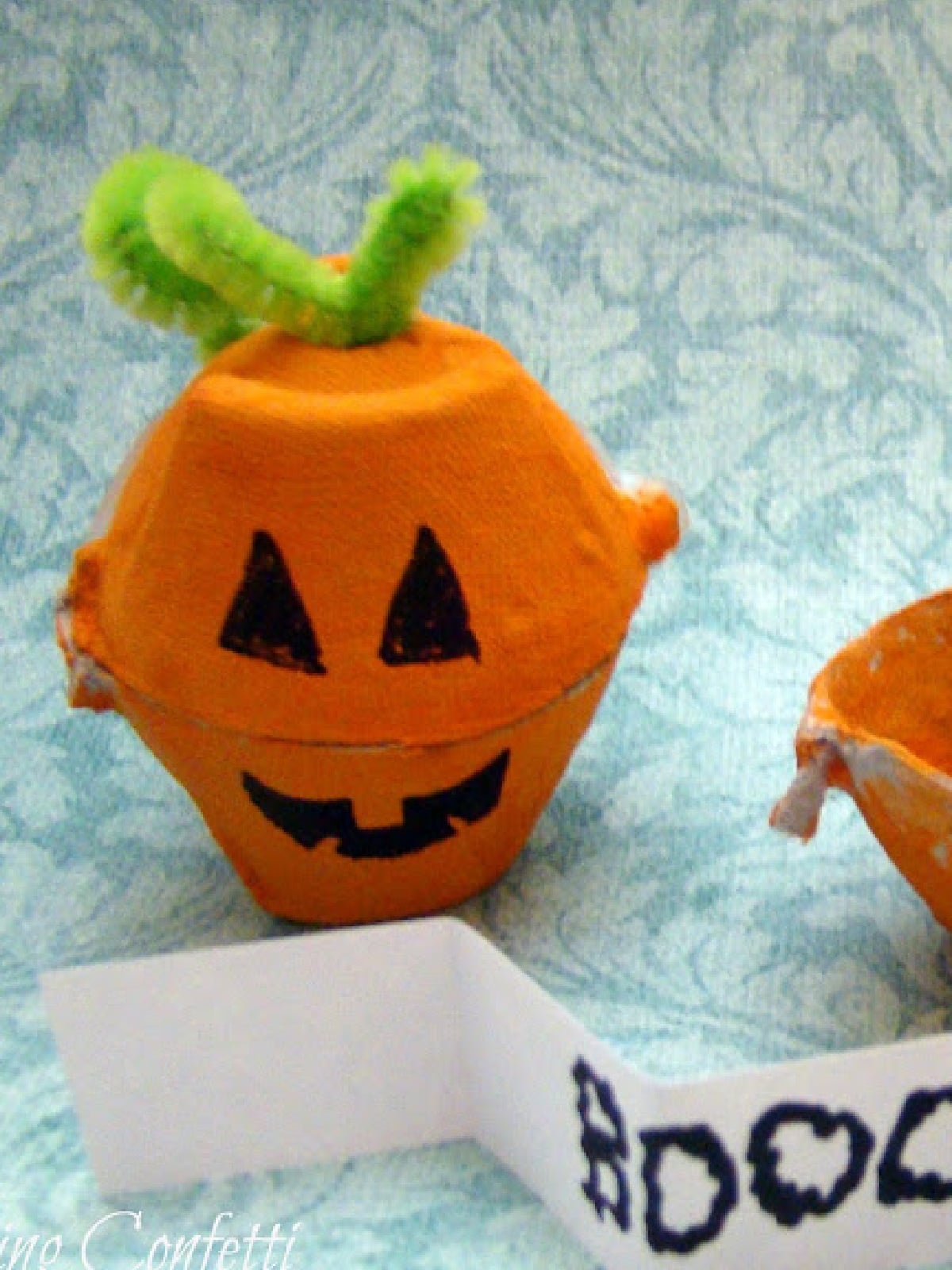 Pumpkin Activities- Cardboard pumpkin cup with green pipe cleaners- Kids Activities Blog