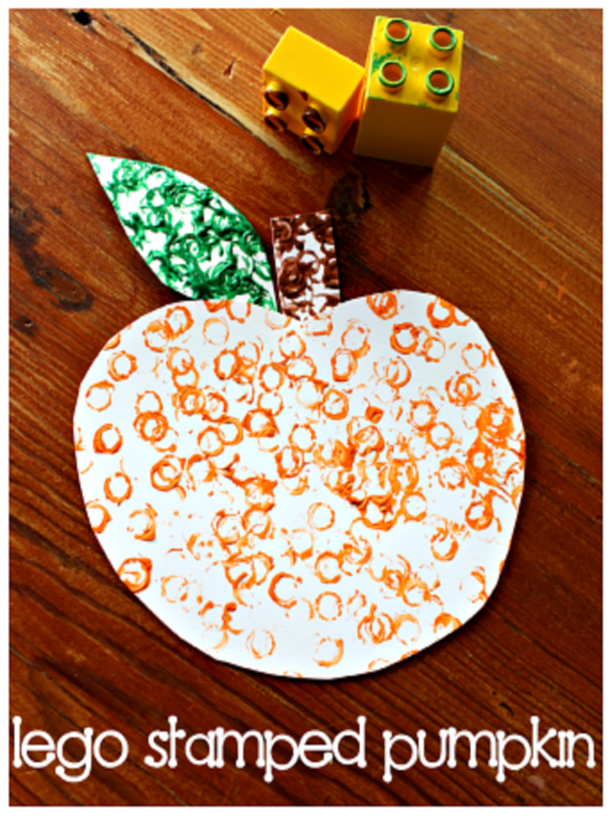 Pumpkin Activities- Lego stamped pumpkin with orange, green, and brown paint- Kids Activities Blog