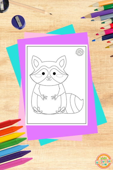 Racoon coloring page- printed pdf file on a wooden background with coloring supplies and colorful accessories- kids activities blog