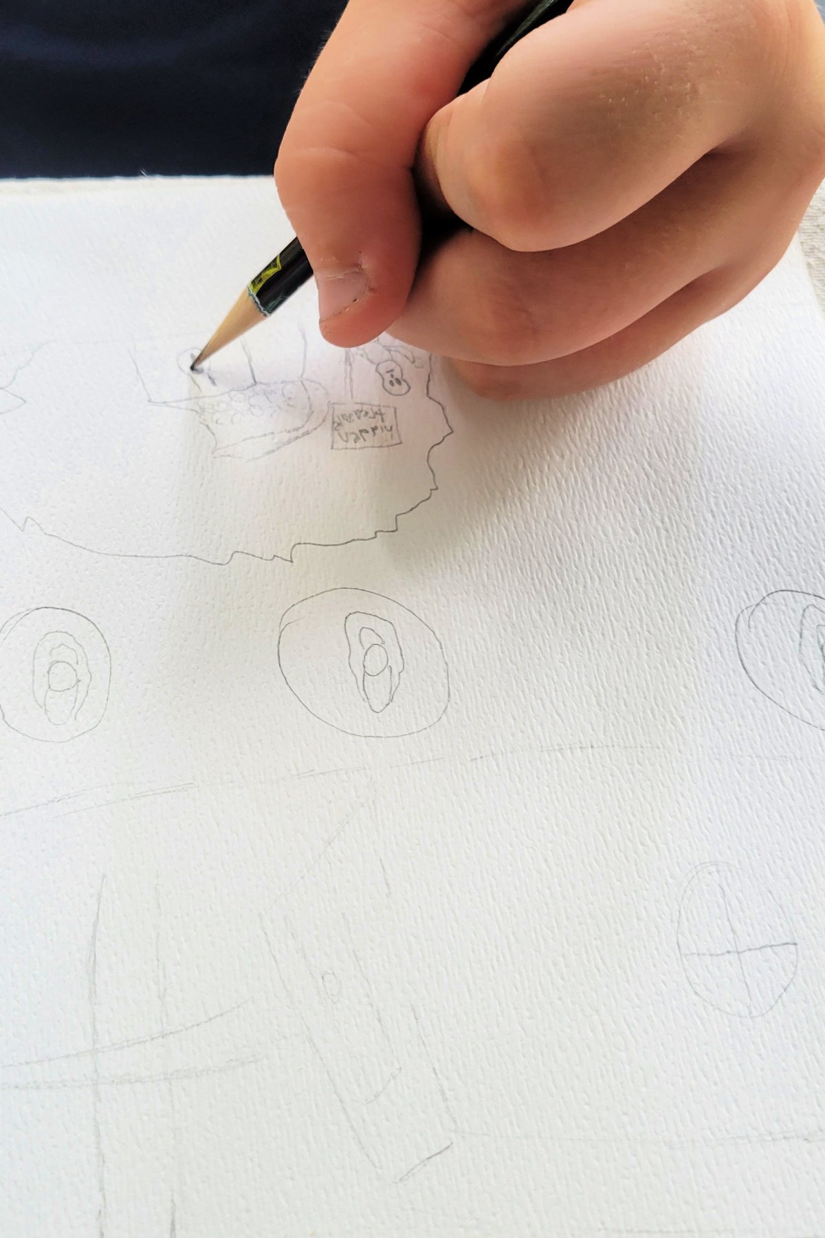 Boy drawing underwater scene with pencil - kids activities blog