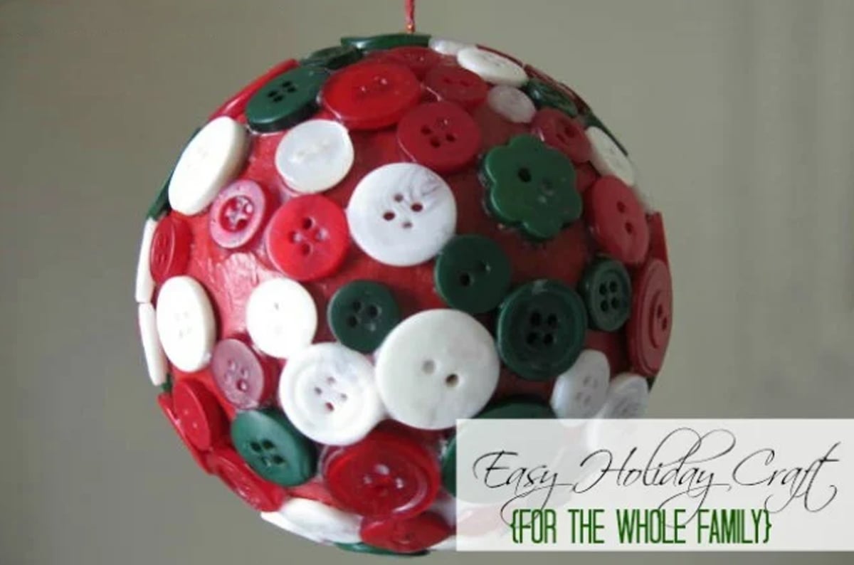 A christmas tree ornament made with buttons in different colors.
