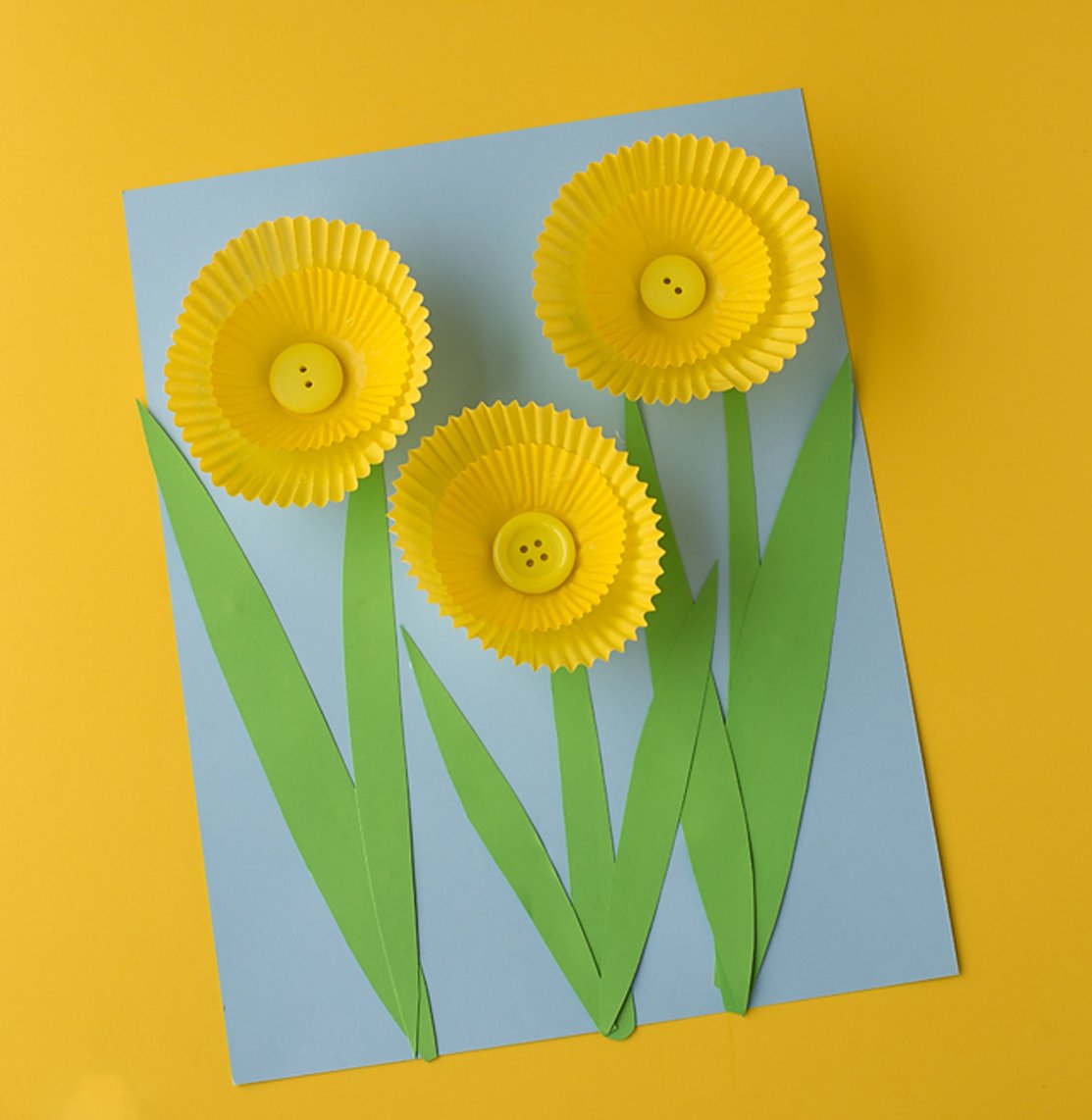A daffodil craft with yellow cupcake liners.