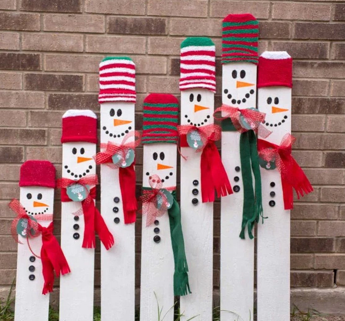 A snowman family made out of wooden sticks to decorate home.