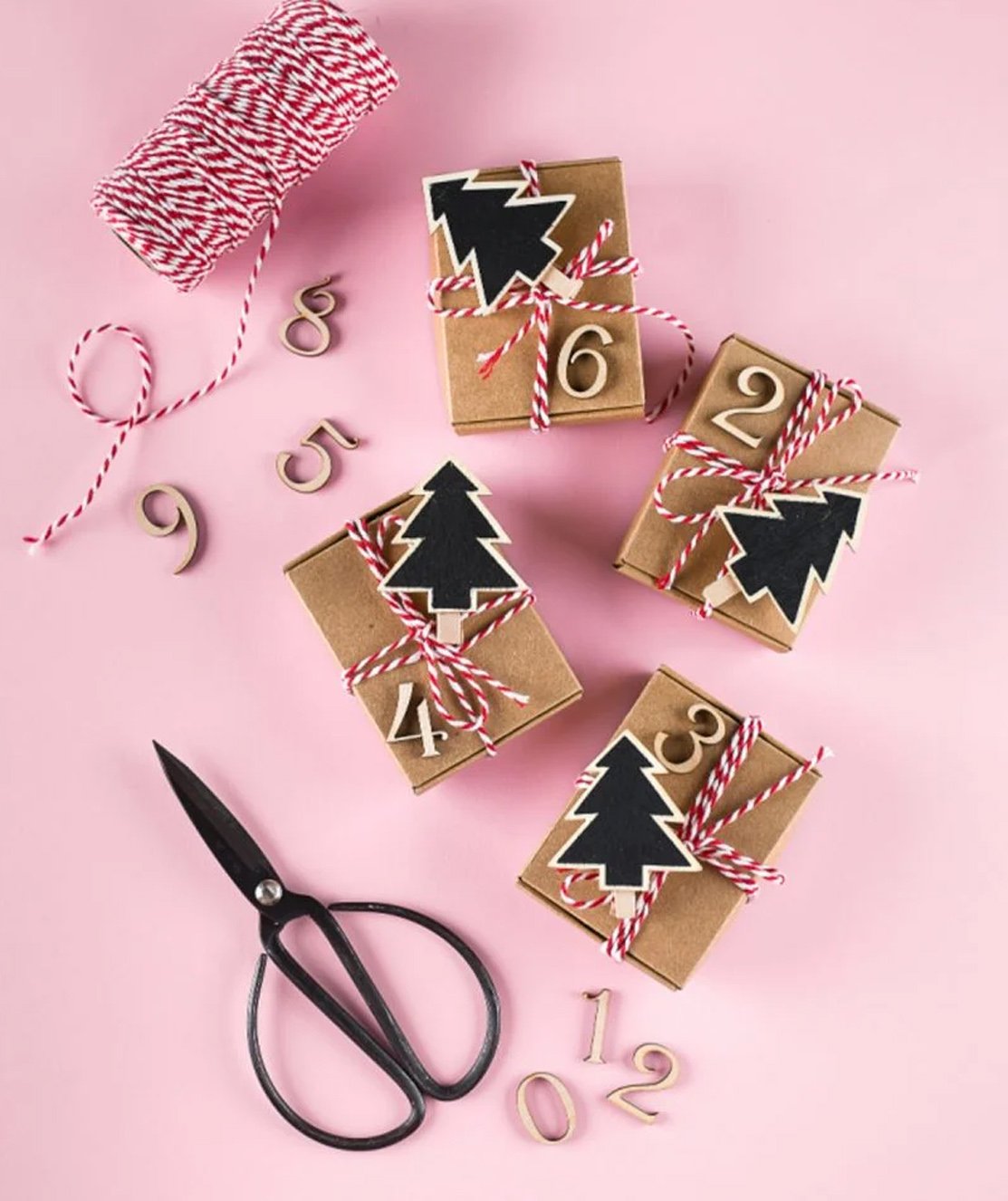 A mixture of craft supplies and the process of making an advent calendar.