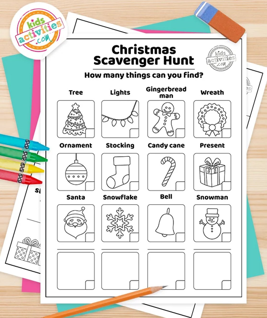 Stack of printed Christmas scavenger hunt printables on top of green and purple pages, with markers next to them, on top of brown background.