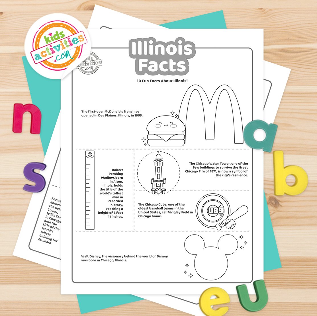 Stack of printed Illinois facts printables on top of green and purple pages, with markers next to them, on top of a brown background.