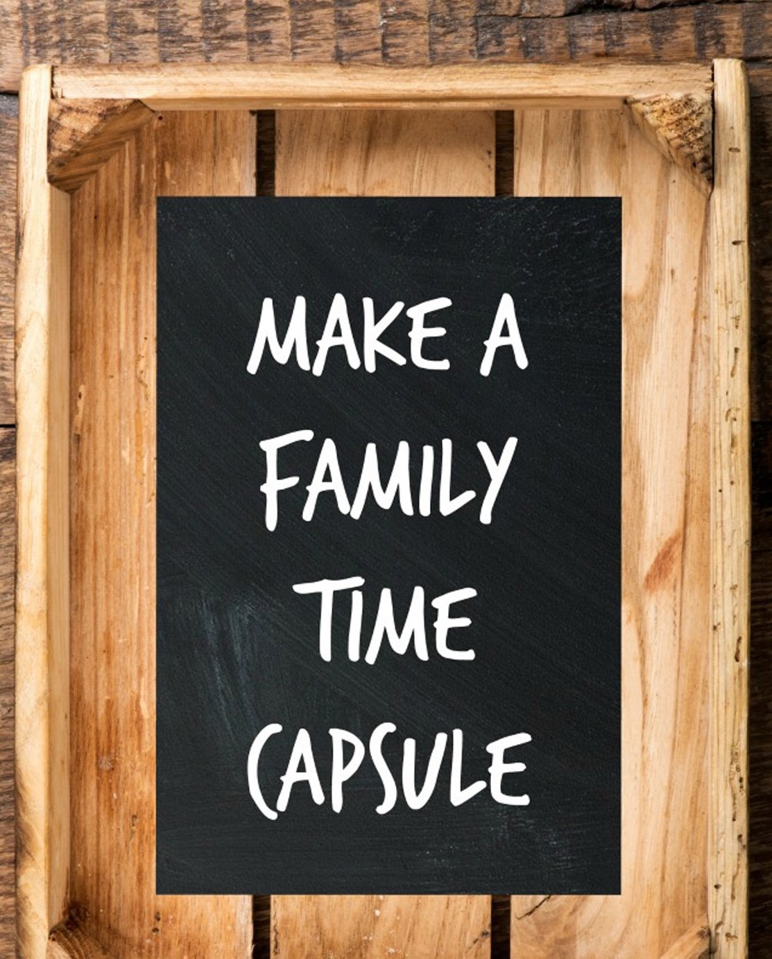 A black sheet of paper with text that reads "make a family time capsule"