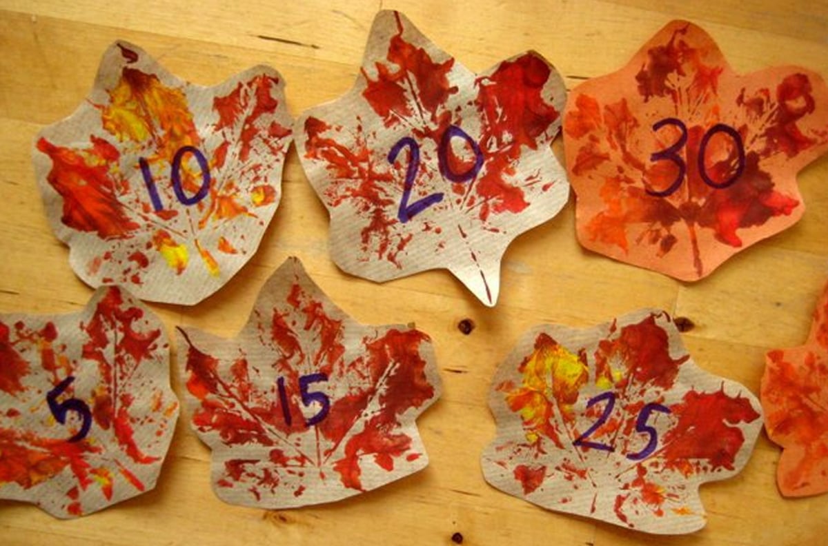Fall leaves with numbers and colors for a math activity.