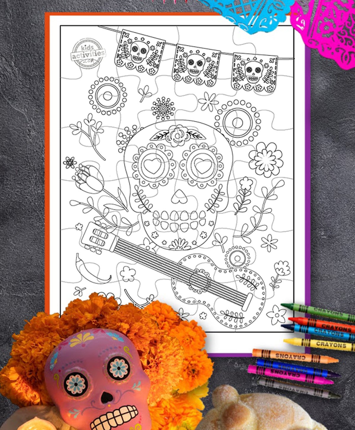 Printed Day of the dead puzzles with marigold decorations and crayons.