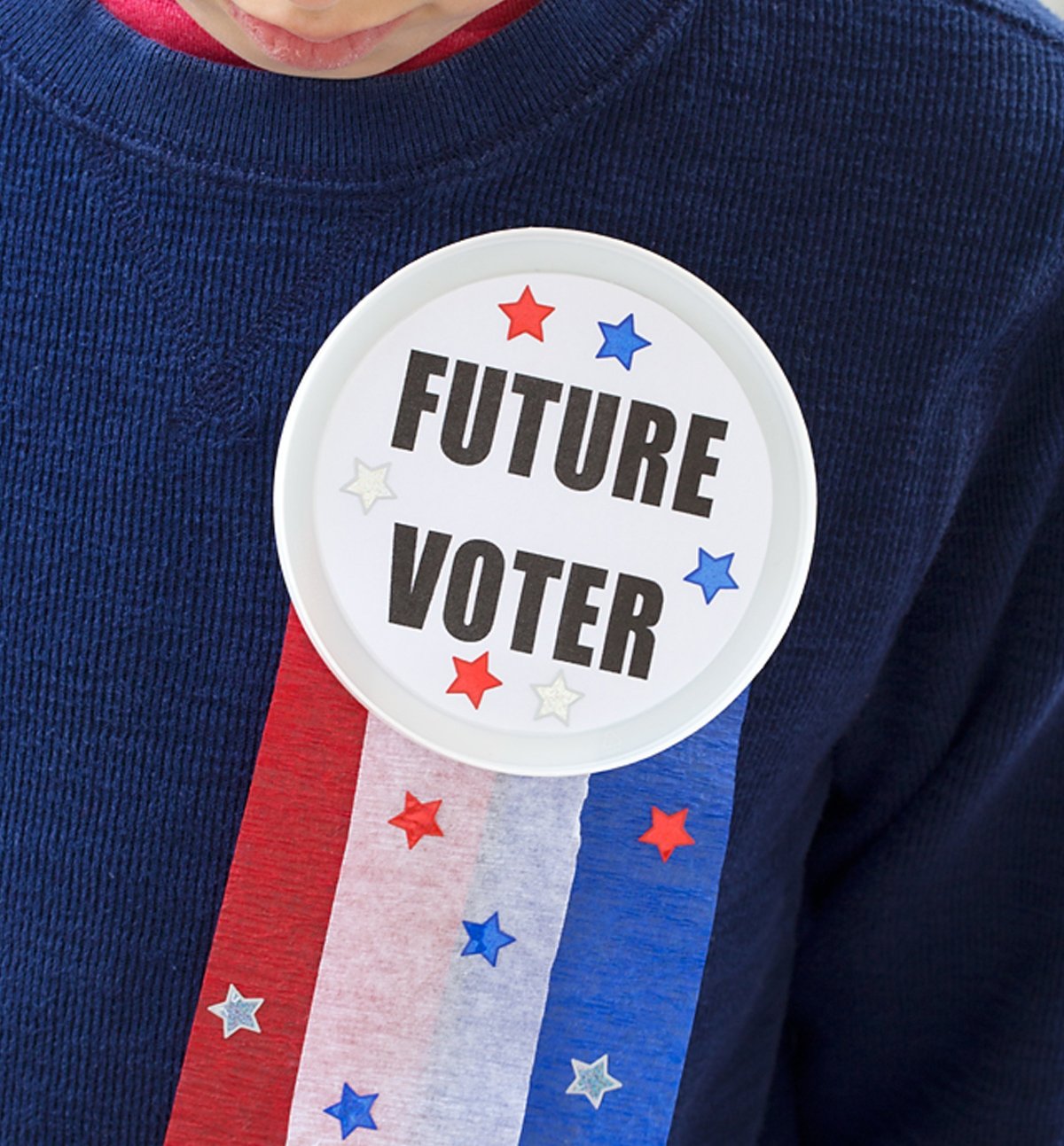A future voter button craft hanging from a sweater.