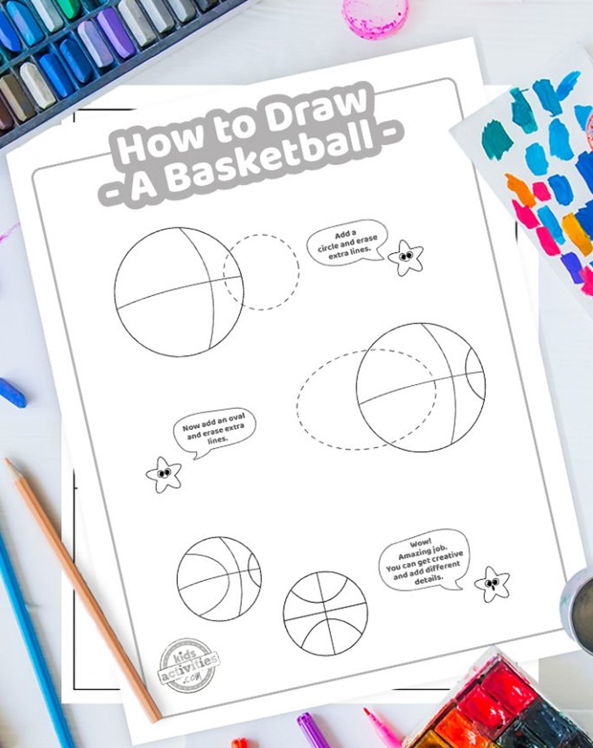 Printed basketball drawing tutorial on top of a blue background with drawing supplies.
