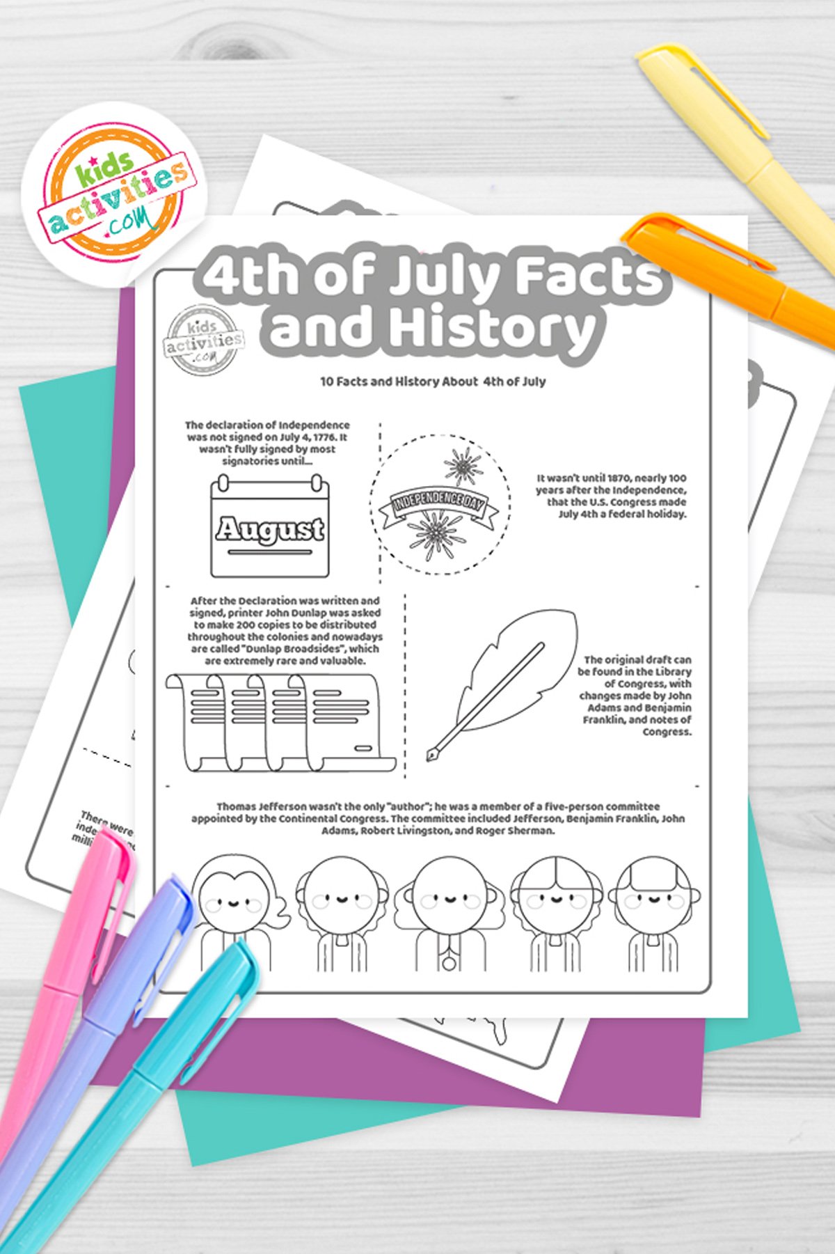 Black and white 4th of July facts coloring pages lying on top of blue-green and purple sheets with assorted crayons on a gray background.