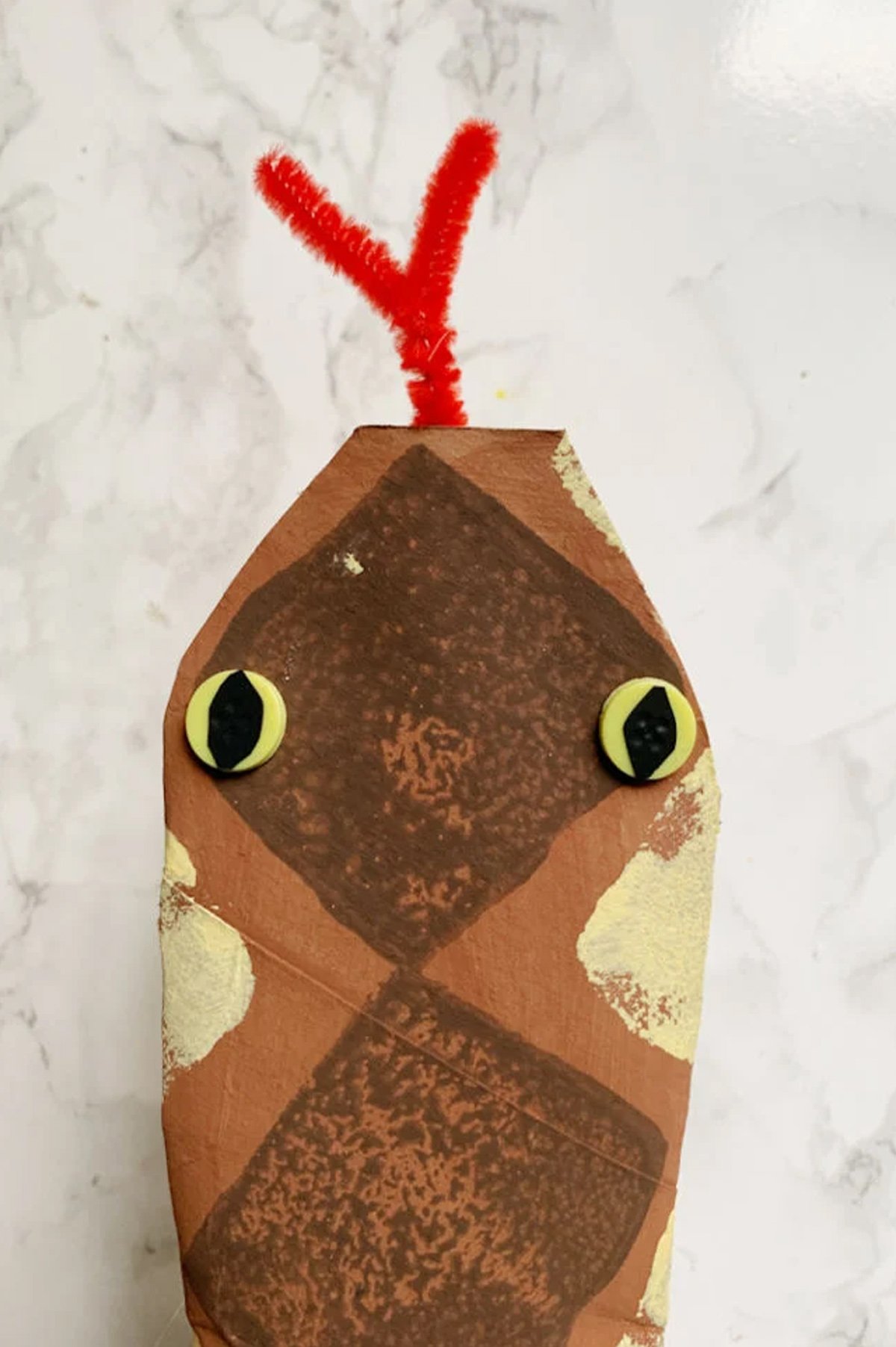 A paper snake craft using toilet paper rolls.