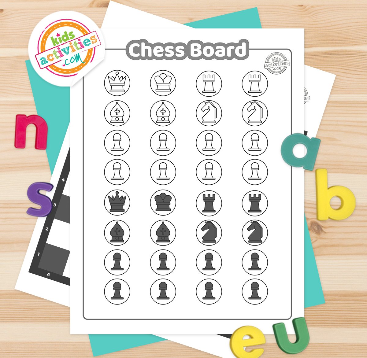 Black and white chess board printables lying on top of blue-green and purple sheets with assorted magnetic letters on a brown background.