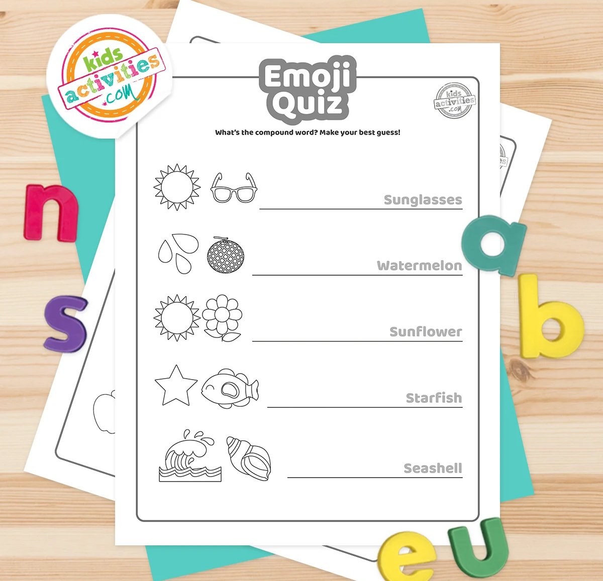 Black and white emoji quiz printables lying on top of blue-green and purple sheets with assorted magnetic letters on a brown background.
