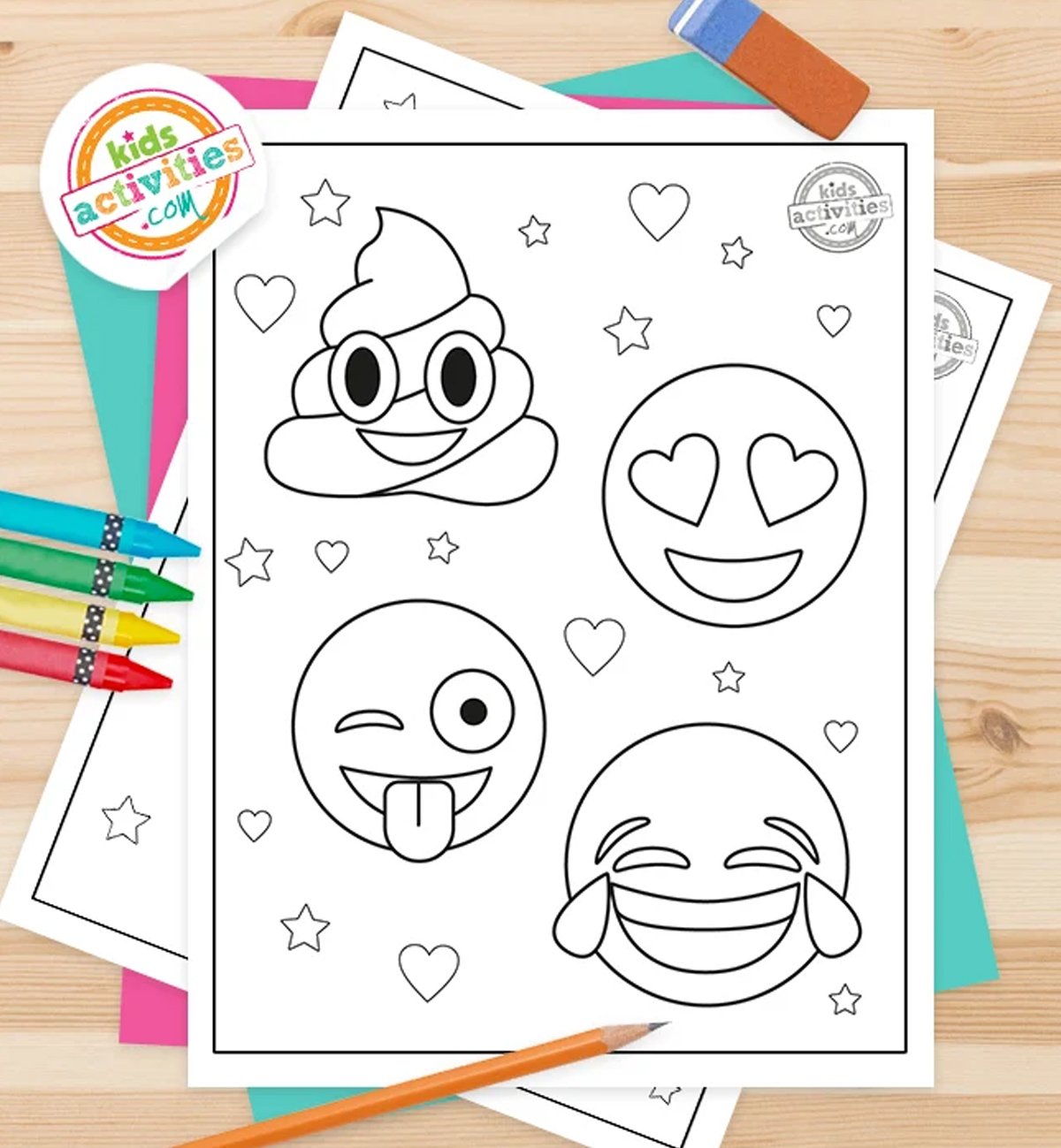 Black and white emoji coloring pages printables lying on top of blue-green and purple sheets with assorted magnetic letters on a brown background.