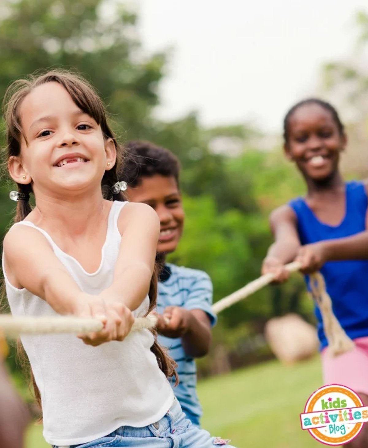 A group of children playing tug of war outdoors.