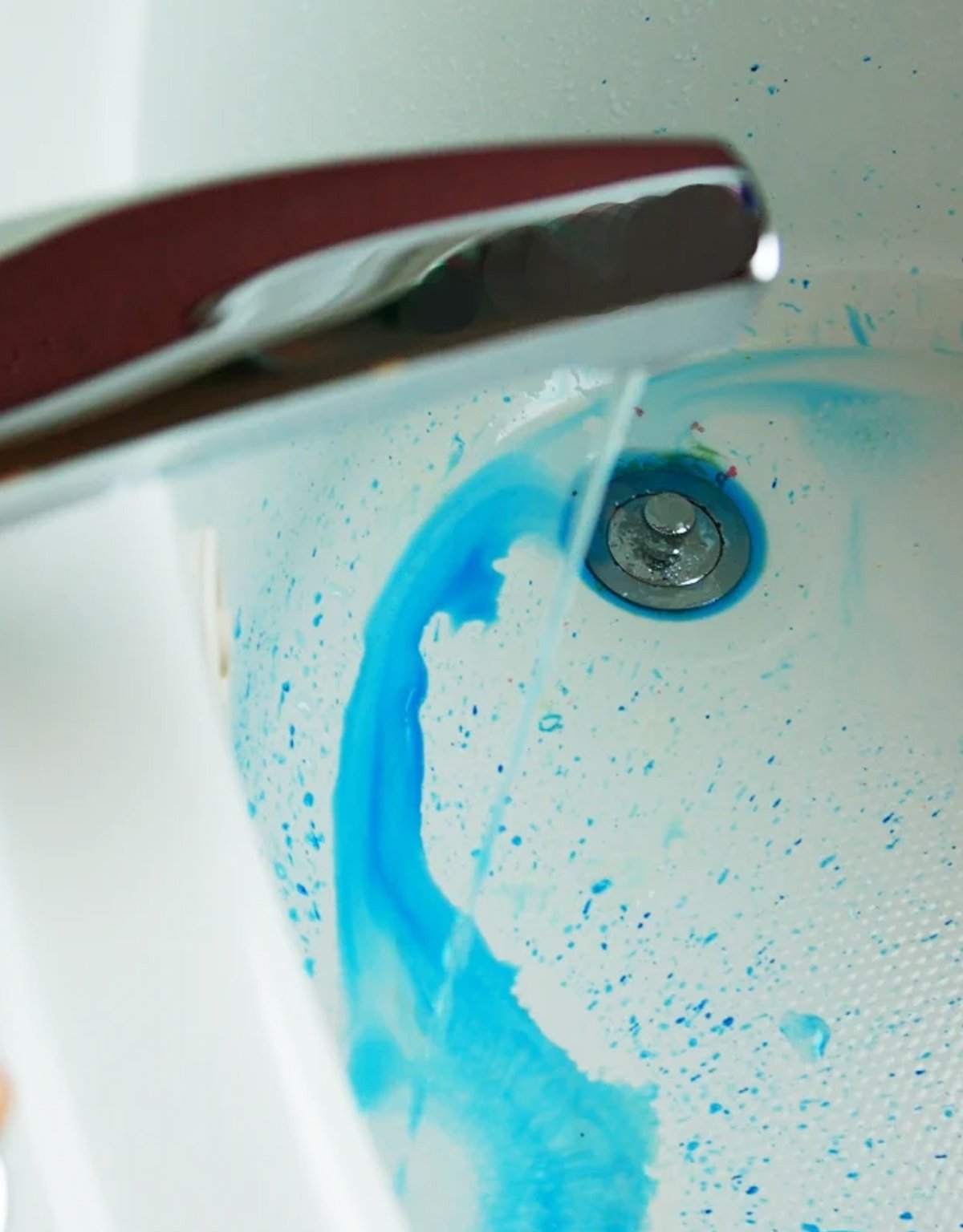 A bath being filled with blue water, for a prank for kids.
