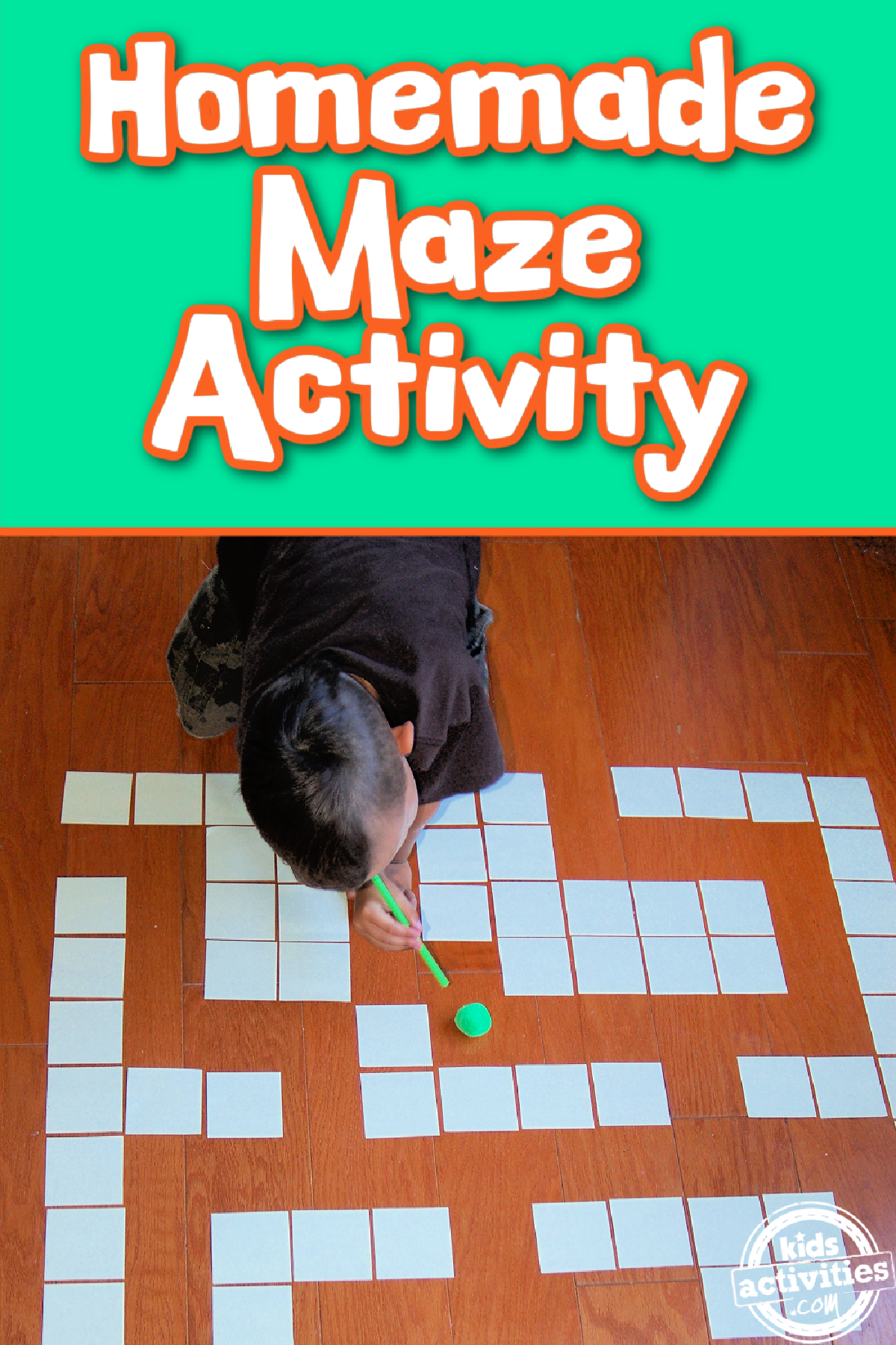 DIY Maze- Little boy blowing a pom pom along a paper maze- kids activities blog