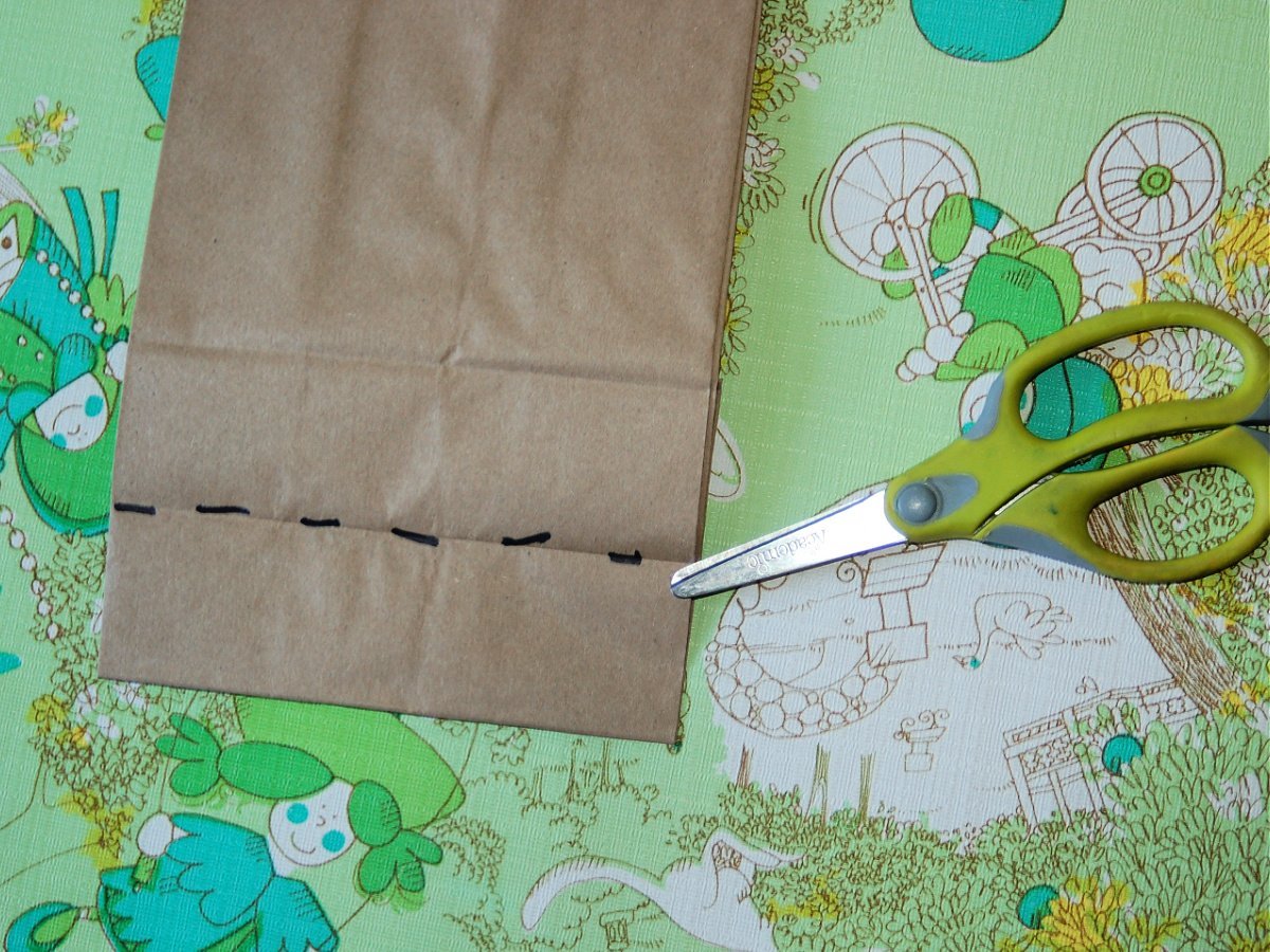 Activity Book- step 1- lines across the paper bag with scissors- kids activities blog