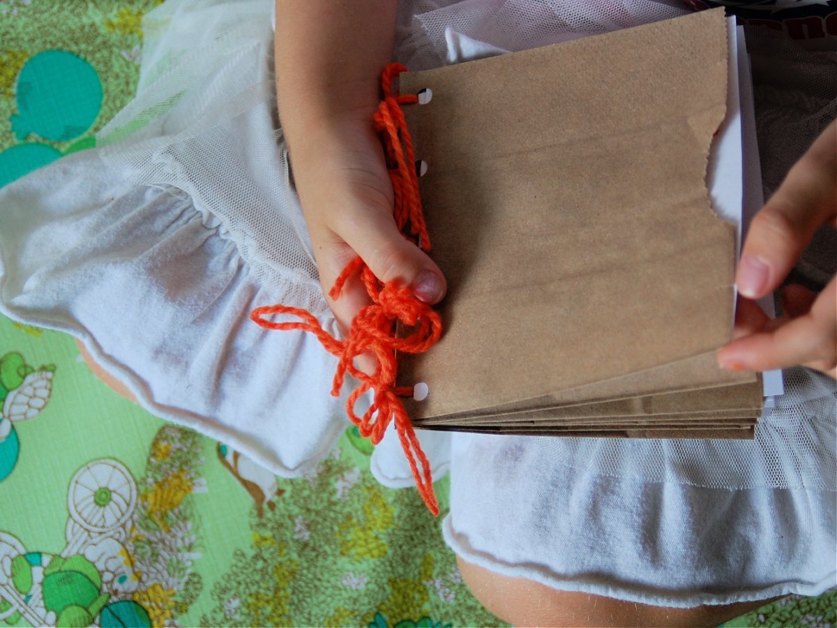 Activity Book- Finished- Girl holding activity book in lap- kids activities book