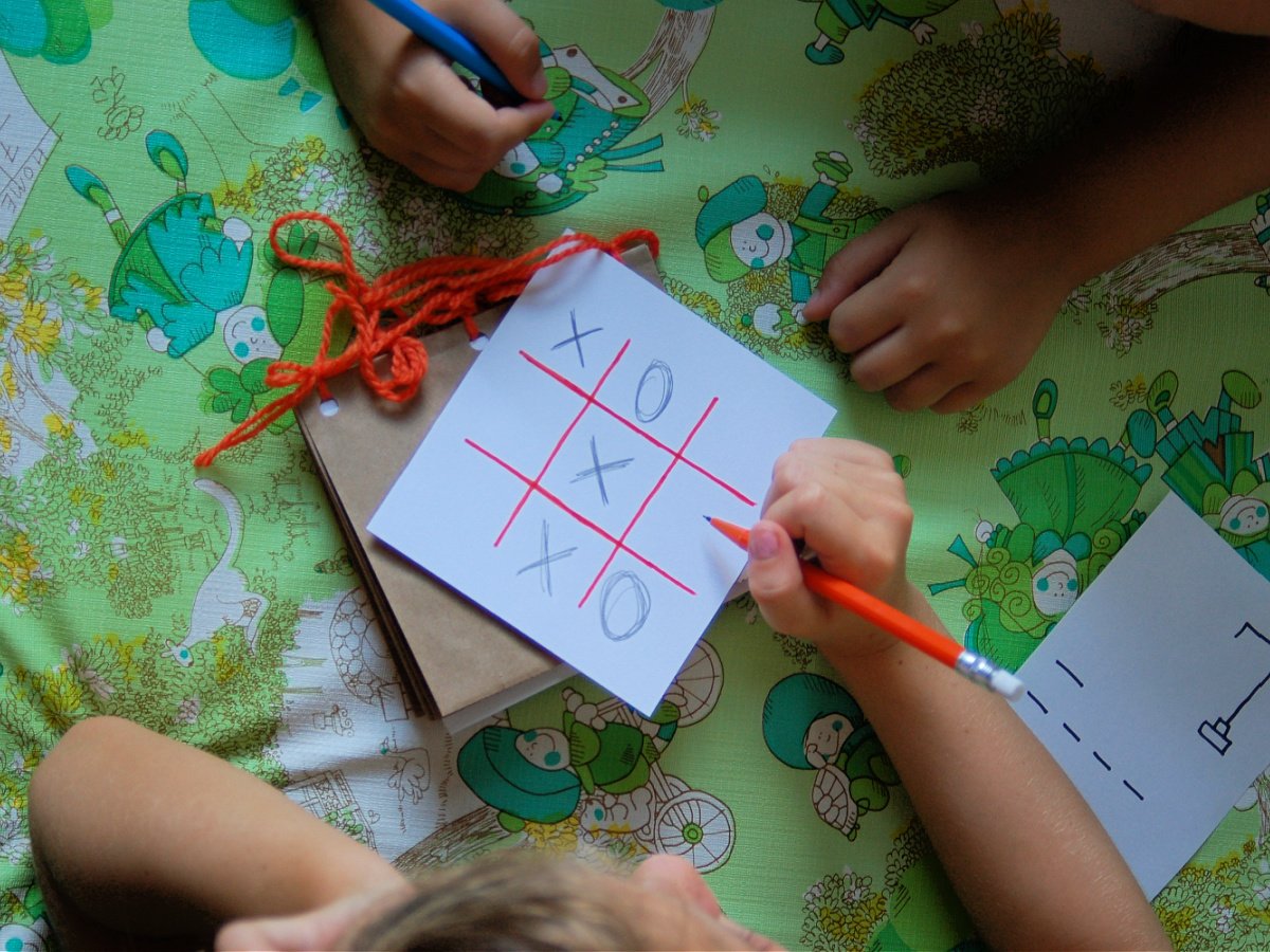 Activity Book- Completed- Kids playing tic tac toe with pencils- kids activities blog