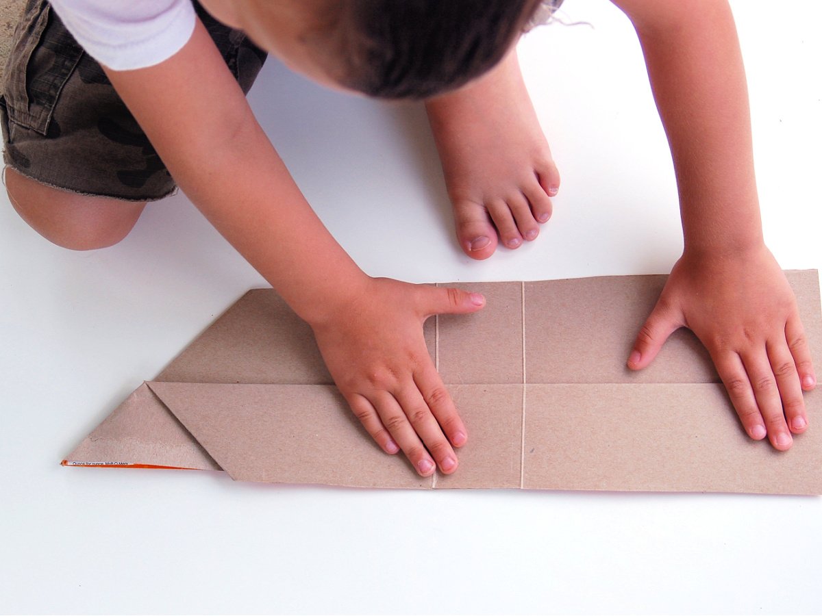 Giant Paper Airplane- Step 4-Now fold the sides in half down - Kids Activities Blog