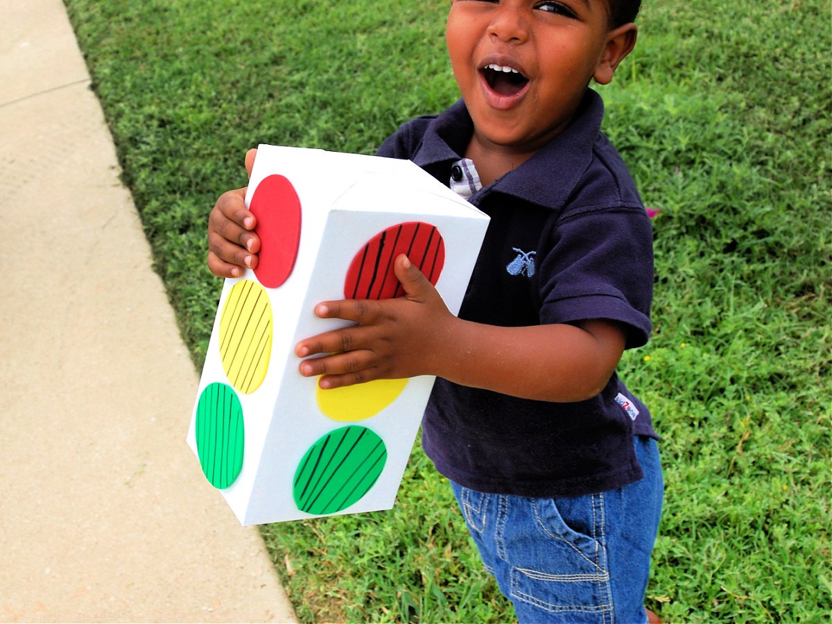 Completed red light green light signal held by a little boy- kids activities blog