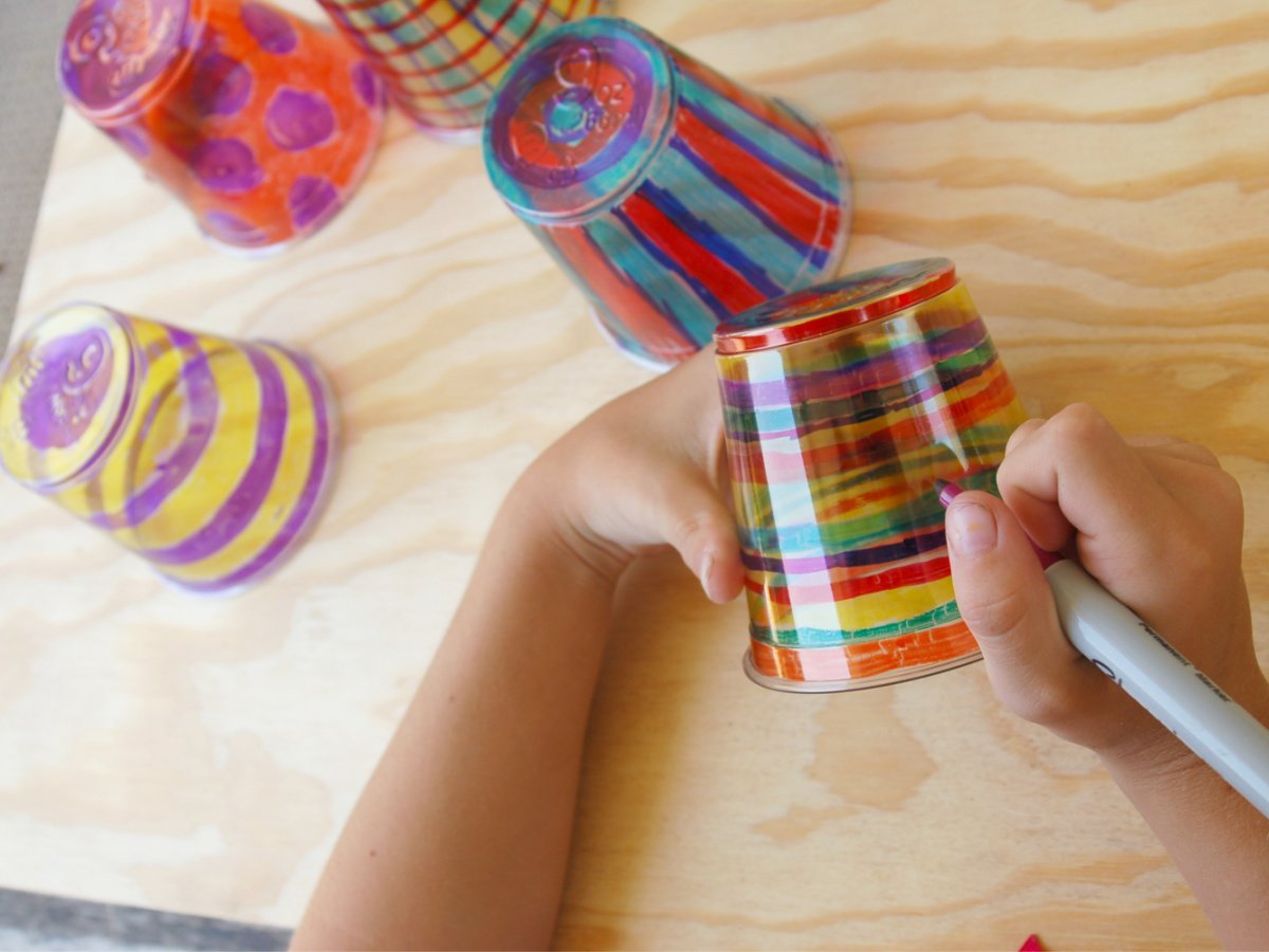 Shrinking plastic cup- step 1- color plastic cups with permanent markers on a wood top- kids activities blog