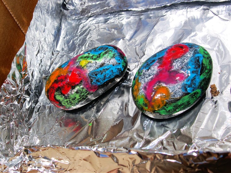 Solar Oven- rocks with melted crayons sitting in a solar oven- kids activities blog