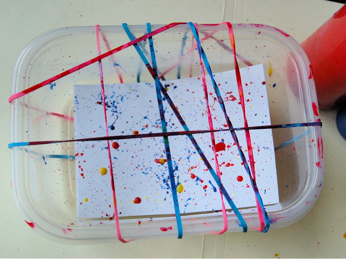 Completed Splatter Paint- red yellow and blue paint on the paper with rubber bands- kids activities blog