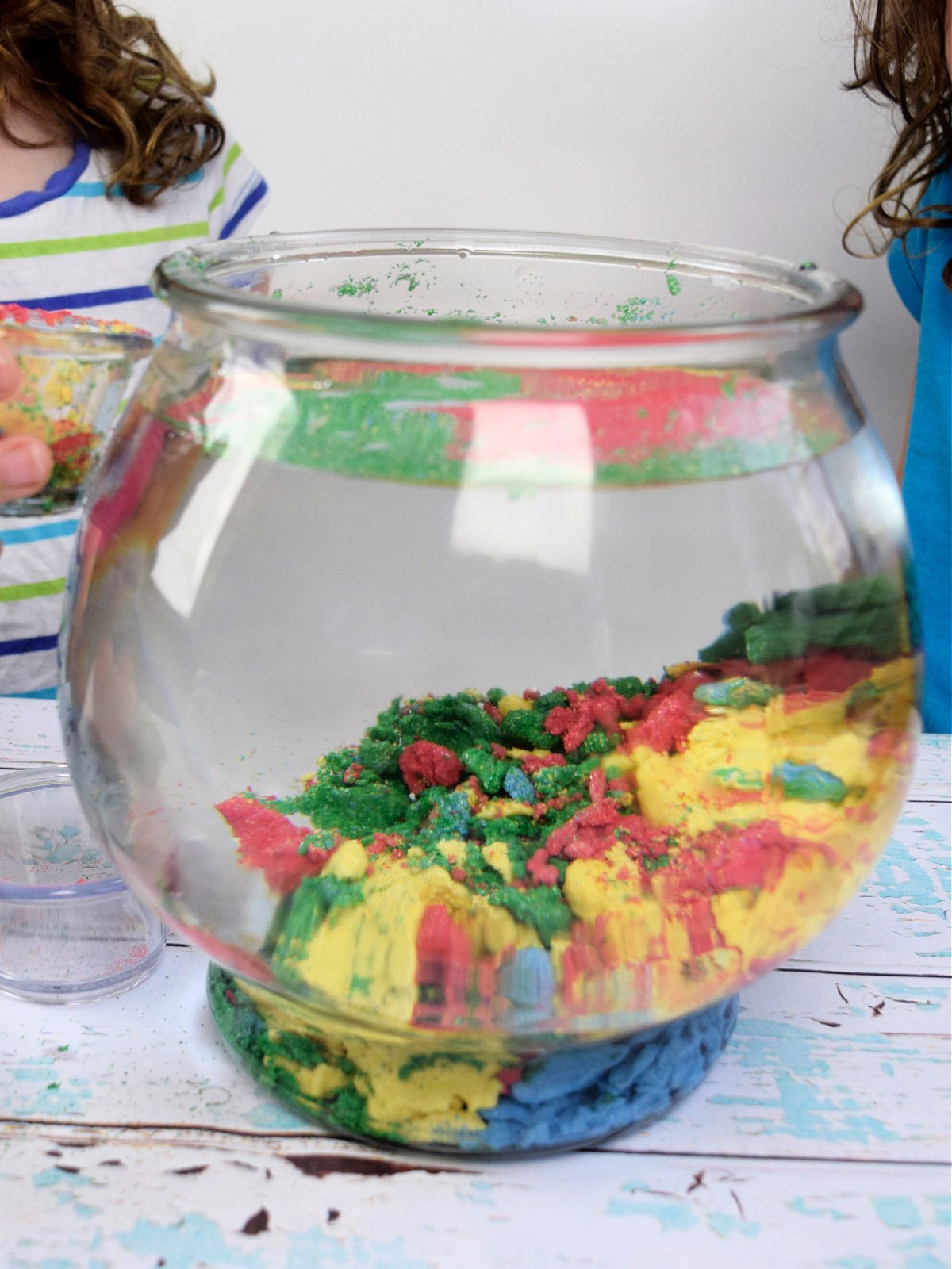 Aqua Sand- Step 5- Green, yellow, blue, red sand in a fish bowl- kids activities blog