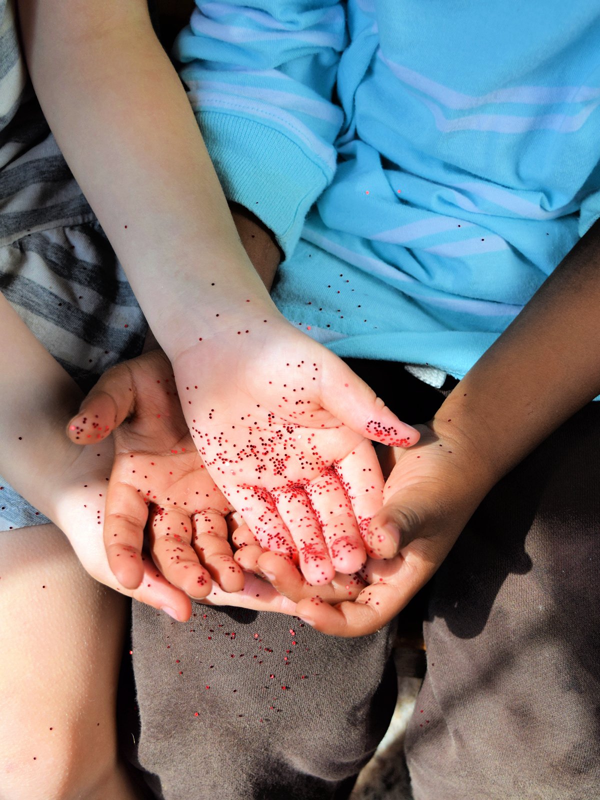 Spreading Germs- Step 4- Hands holding other hands with glitter everywhere- kids activities blog